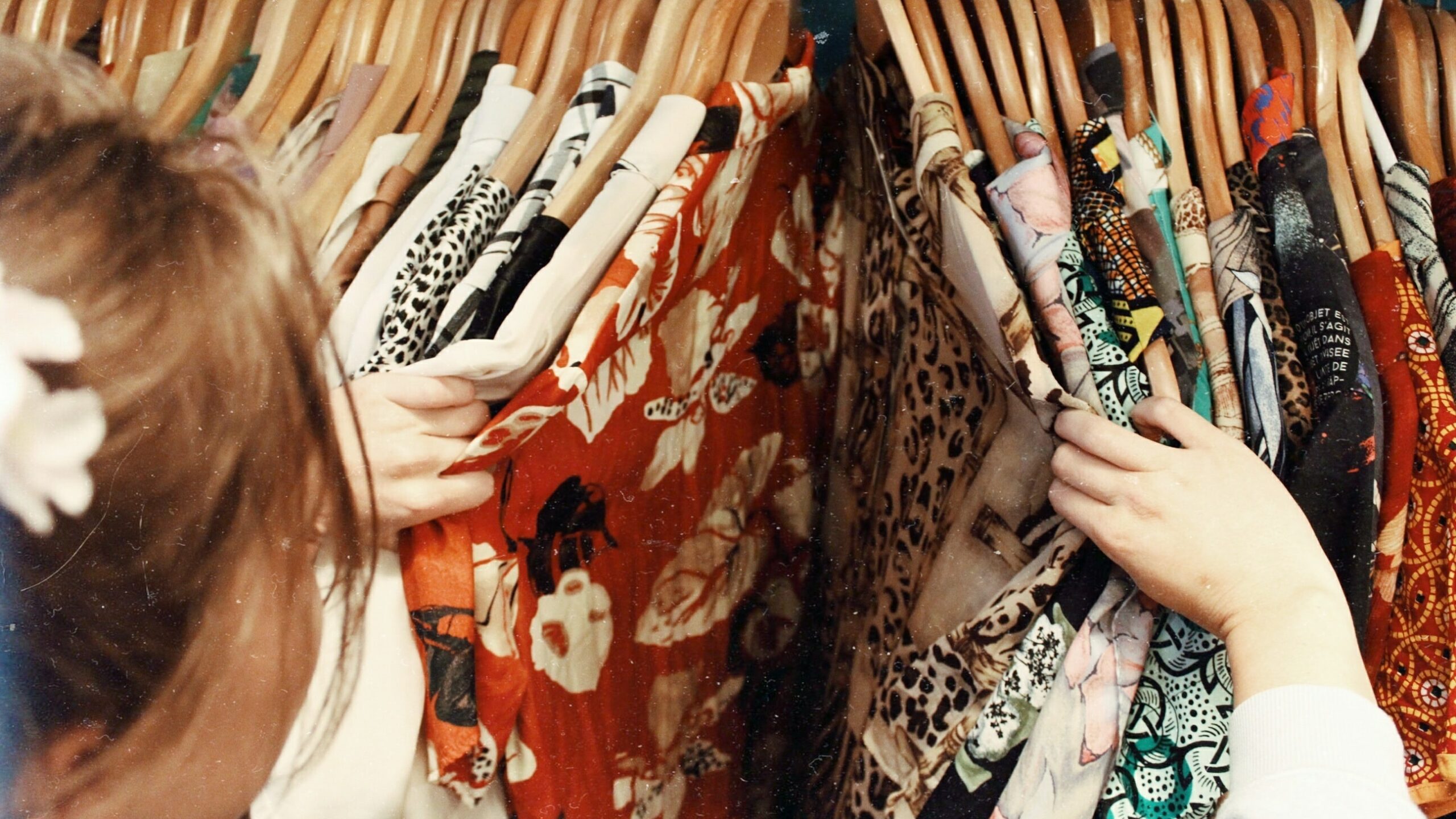 Person browsing shirts in a shop