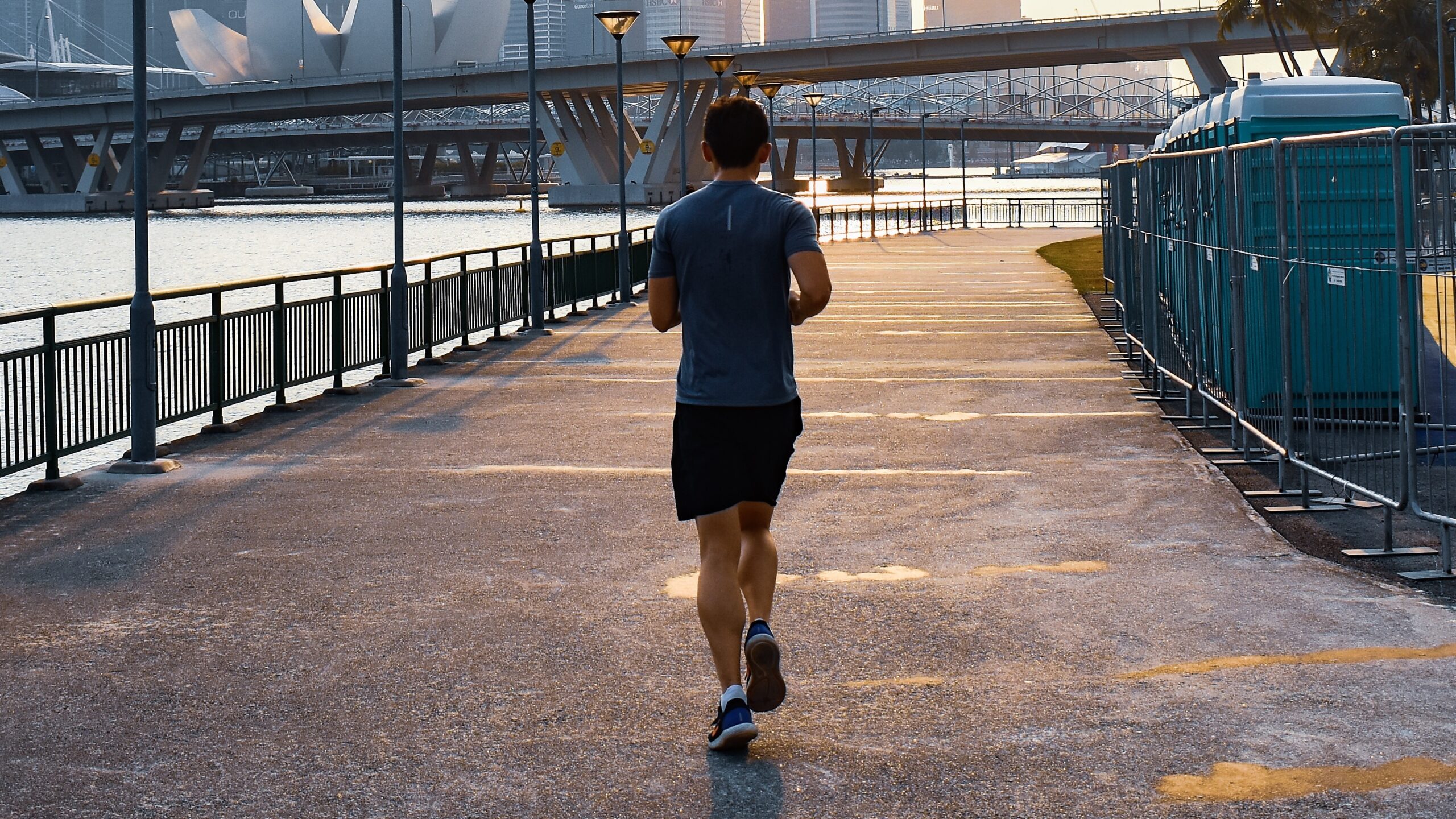 The back of a man jogging in a city