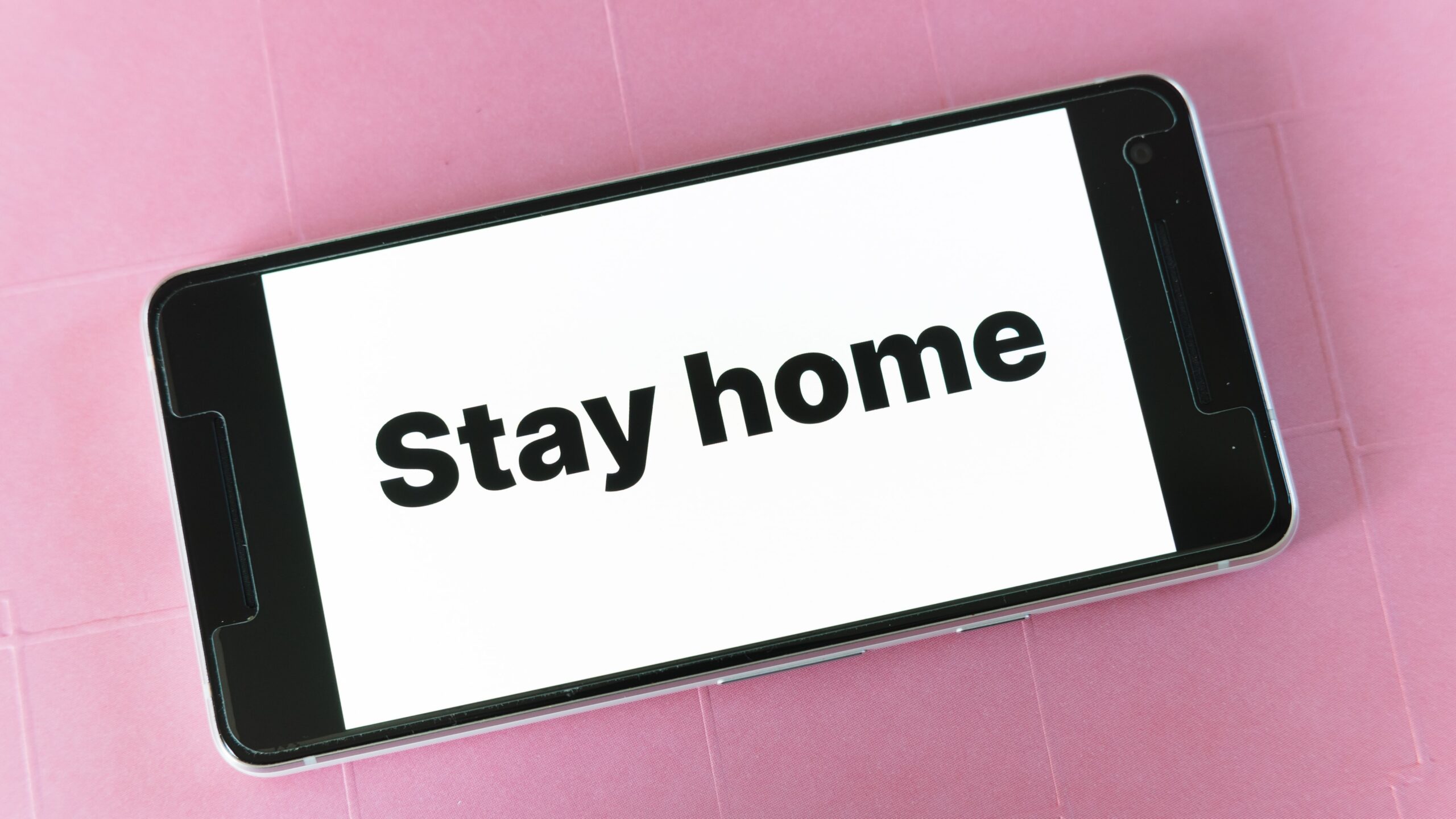 Phone with 'stay home' on screen